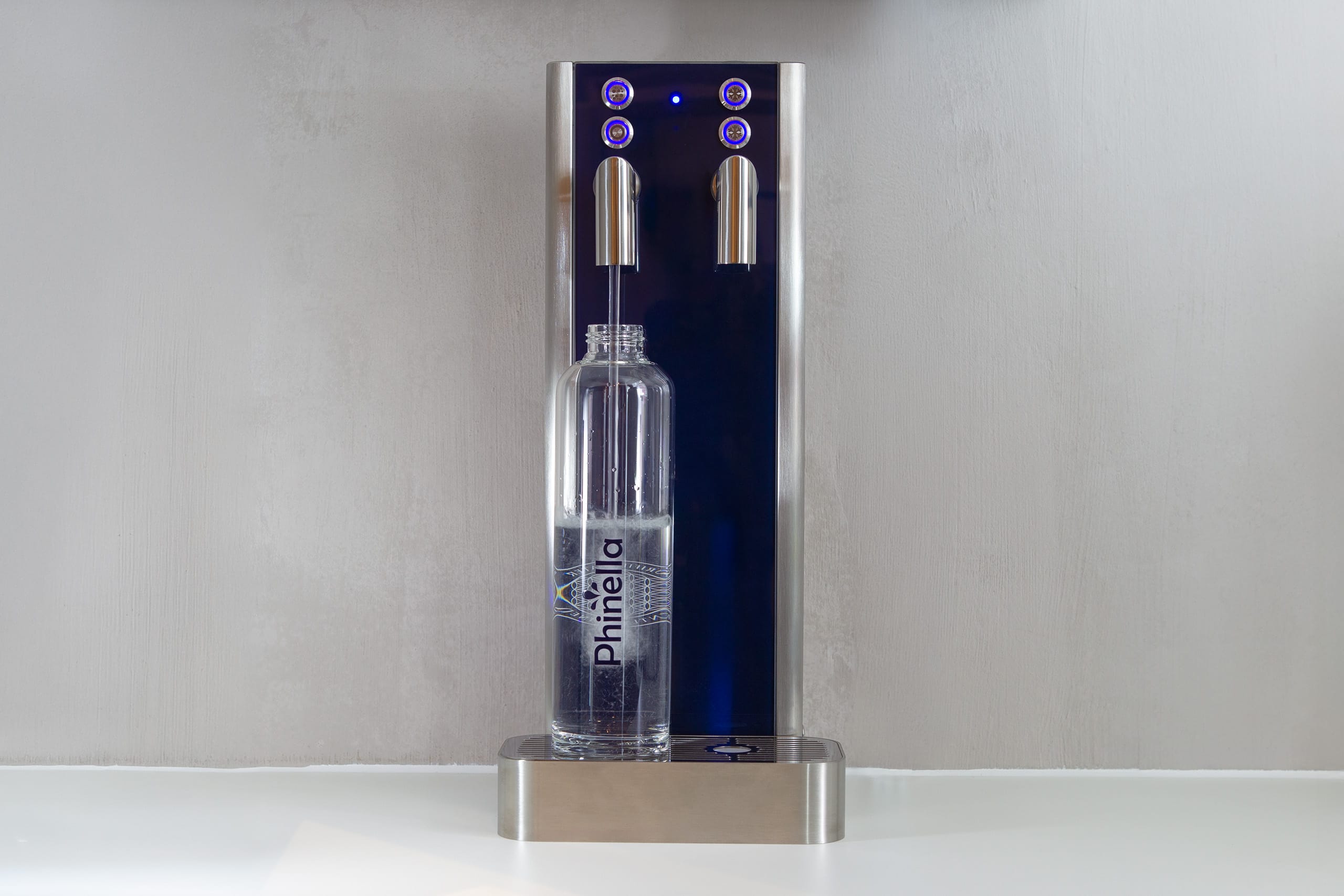 Phinella bottle is filled on the water dispensing system