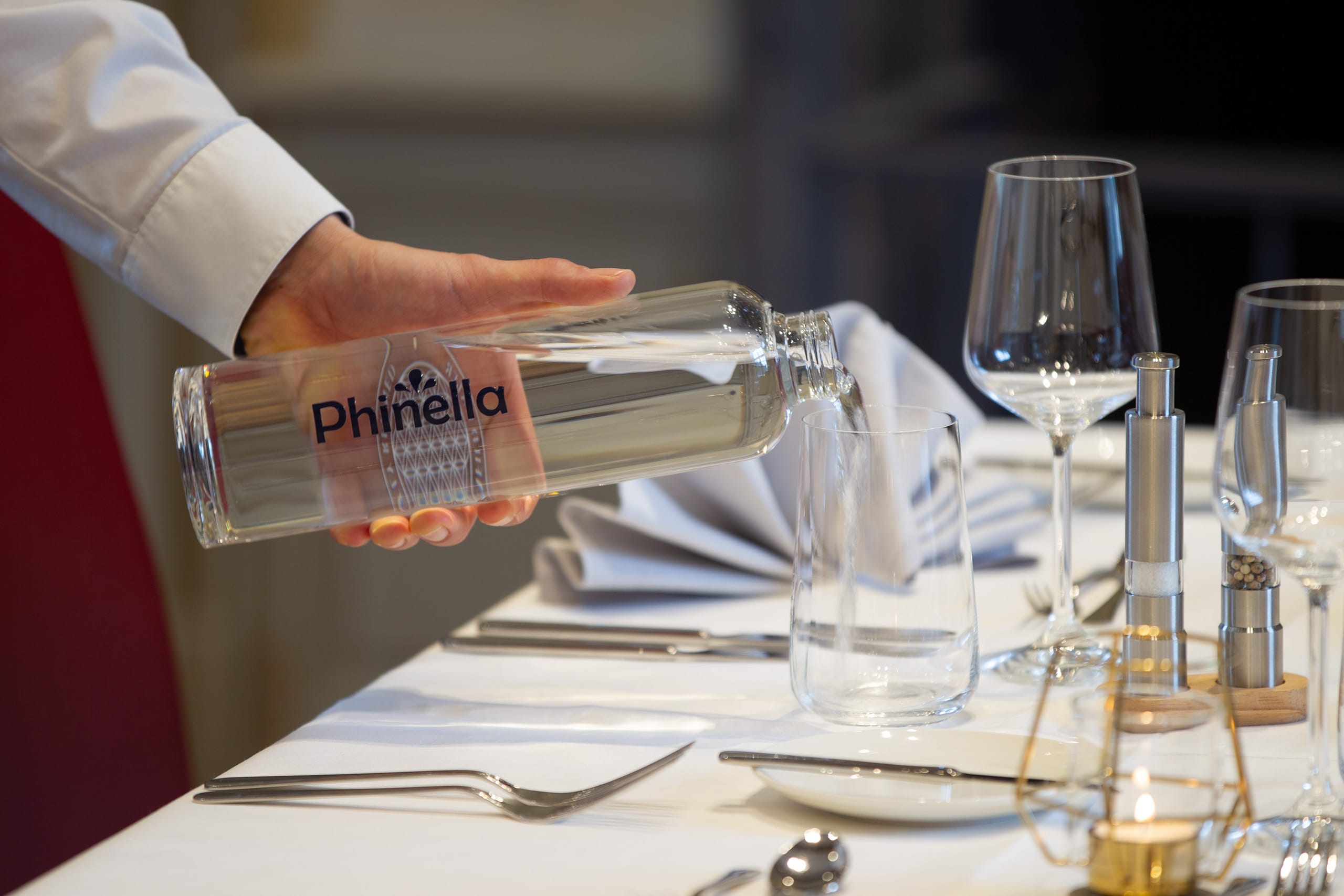 Phinella water is poured into a glass